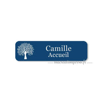 Badge plastique personnalisé bleu avec écriture blanche, exemple avec prénom Camille et fonction Accueil.